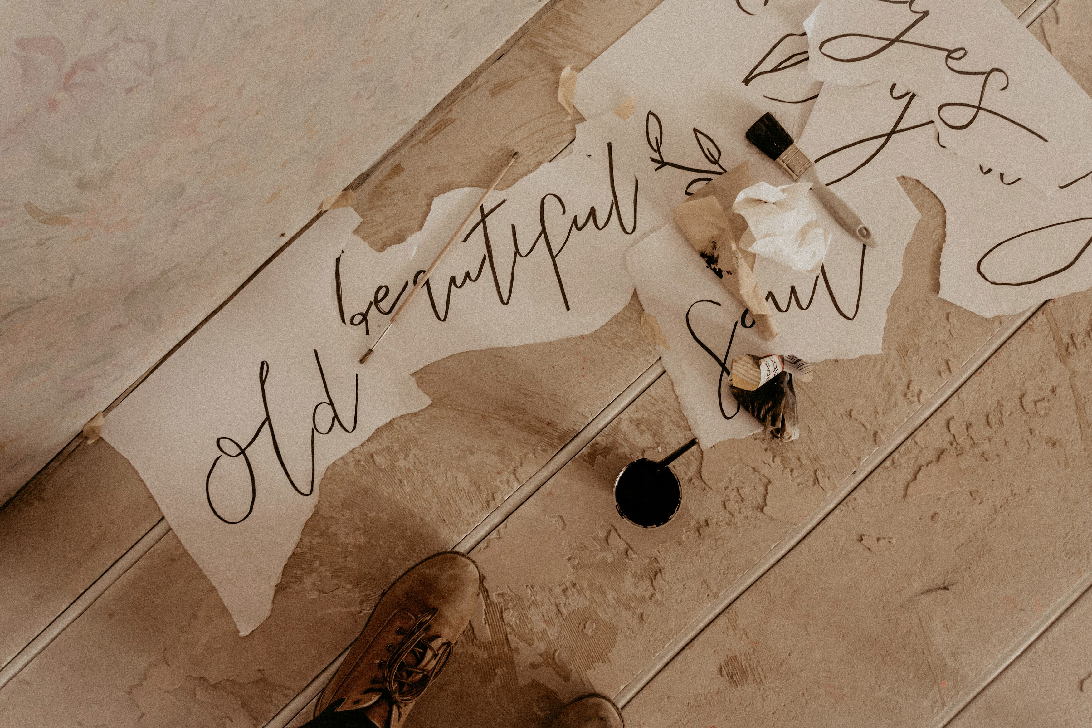 person in brown leather shoes standing on white floor tiles